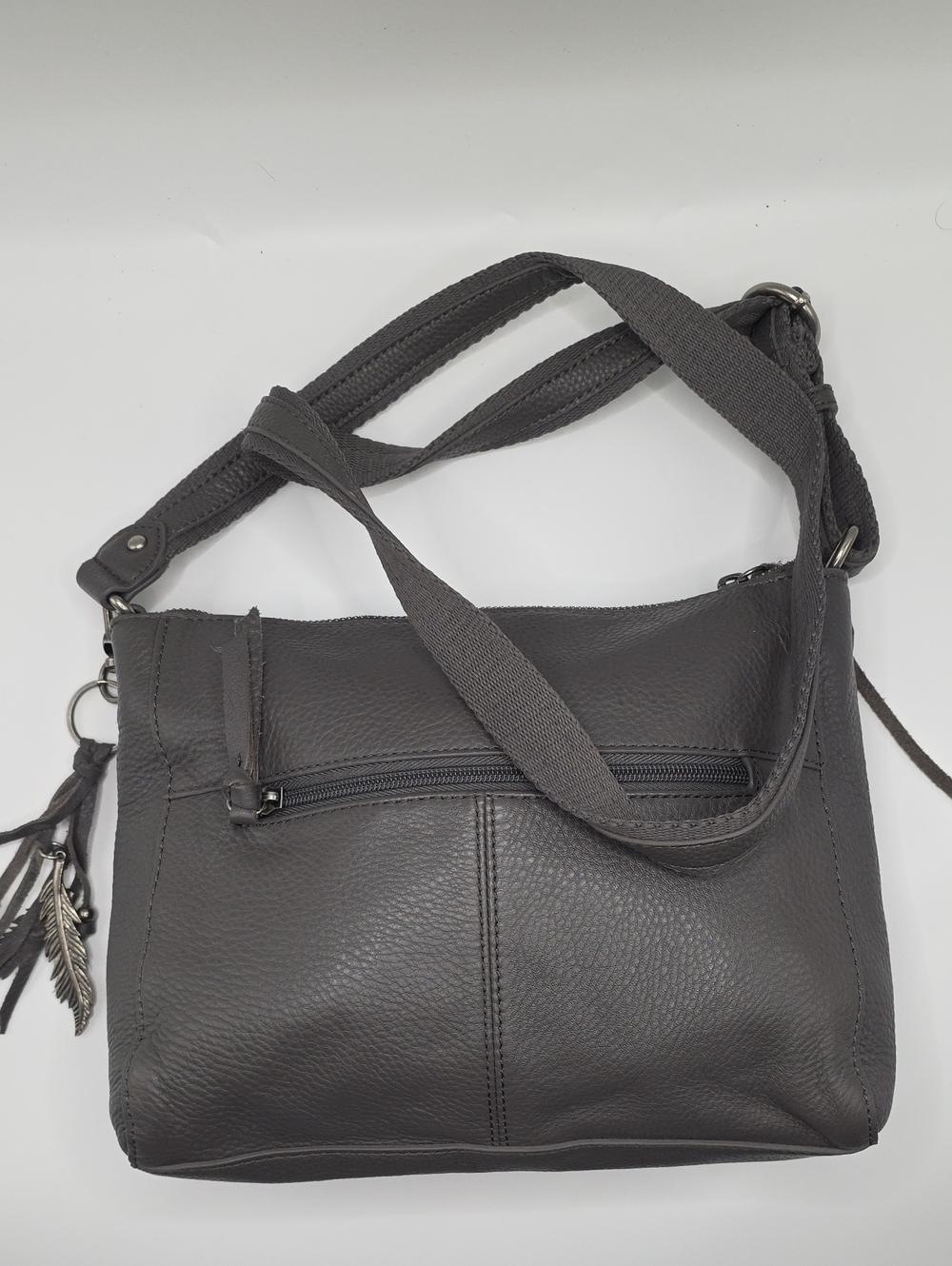 The Sak Dark Gray Pebbled Leather Crossbody Bag with Tassel Charm